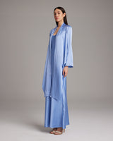 Model wearing a periwinkle silk Featherlight Wrap Blouse with long front sashes.