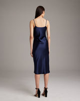 Back view of a navy satin midi slip dress
