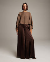 Model wearing a brown bolero over brown wide-leg pants