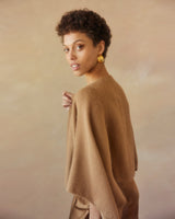 Model wearing a camel-colored Alpaca Crop Top with a soft background