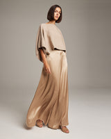 Model wearing a beige alpaca crop top with satin pants