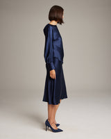 Model wearing a navy silk charmeuse bias midi skirt and matching blouse