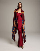Model wearing the Cascade Wrap in Rouge and Burnt Orange with Deep Sea Blue accents