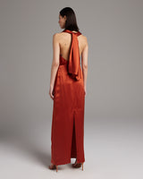 Model wearing a backless convertible halter dress in tomato color