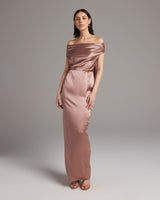 Model wearing a rose-colored convertible halter dress with off-shoulder design