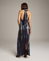Back view of a model wearing a Midnight Tie Dye Convertible Dress, showcasing the halter neck and wrap sash.