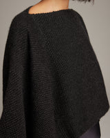 Close-up of a model wearing a black alpaca crop top, showcasing the texture and fit.