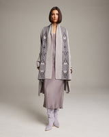Model wearing a Wide Diagonal Alpaca Wrap with geometric patterns in grey and ivory.