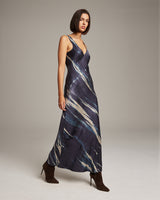 Model wearing a midnight double V tie dye dress with a flowing design