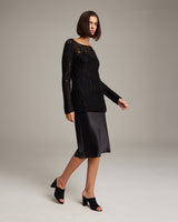 Model wearing a black Open Mesh Boatneck Sweater with a satin skirt and heels