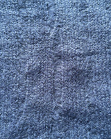 Close-up of textured navy ribbed fabric of a cropped sweater