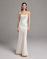 Model wearing a liquid silk slipdress in ivory, showcasing its elegant design.