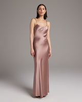 Model wearing a rose-colored liquid silk slipdress, showcasing its elegant fit.