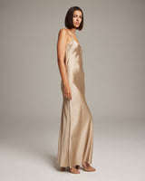 Model wearing a liquid silk slipdress in champagne color