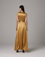Back view of a model wearing a gold Frontward Wrap Dress