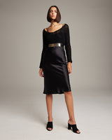 Model wearing a Plated Leather Wrap Belt with a black dress