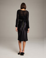 Model wearing a black outfit with a Plated Leather Wrap Belt from the back