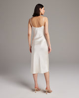 Back view of a Midi Slip Dress in ivory, showcasing its elegant drape and straps.
