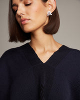 Model wearing Millapani Lukutuwe Sapphire Stud Earrings, showcasing their design and style.