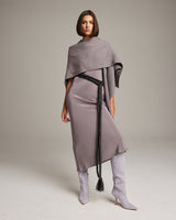 Model wearing a grey dress with a black rope belt and grey boots