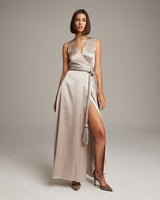 Model wearing a beige dress with a rope belt and tassel