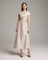 Model wearing a linen bralette wrap top with a tied sash in a neutral color.