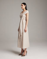 Model wearing a Linen Bralette Wrap Top in a neutral color, showcasing the front tie detail.