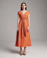 Model wearing a persimmon Linen Bralette Wrap Top with long front sashes