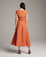 Model wearing a persimmon Linen Bralette Wrap Top from the back, showcasing the long front sashes.