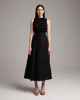 Model wearing a black Butterfly Wrap Skirt with a sleeveless top