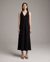 Model wearing a black linen V neck maxi dress