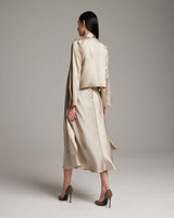 Model wearing a silk Featherlight Wrap Blouse in Bone, showcasing the back view.