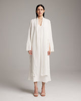 Model wearing a Linen Featherlight Wrap Blouse in Ivory