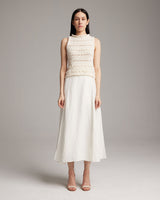 Model wearing a Longer Flammé Knit Crop Top with a white skirt