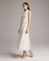 Model wearing a Longer Flammé Knit Crop Top in ivory with a long skirt