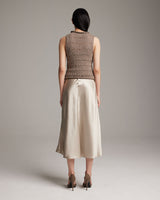 Back view of a model wearing a Longer Flammé Knit Crop Top in a neutral color