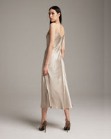 Model wearing a beige V-neck slip dress from the back