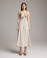 Model wearing a beige Butterfly Wrap Skirt with a satin top