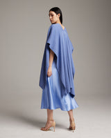 Model wearing a solid cotton duster in cornflower blue, showcasing its drape and style.