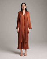 Model wearing a brown Silk Featherlight Wrap Blouse with long sleeves and front sashes