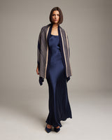 Model wearing a navy Striped Zig Zag Shawl over a satin dress