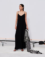 Model wearing a black Parachute Slip Dress with a striped shawl