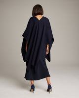 Model wearing a navy solid alpaca duster from the back