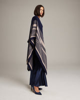 Model wearing a navy and taupe striped zig zag duster, standing in profile.