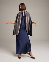 Model wearing a navy Striped Zig Zag Shawl over a satin dress