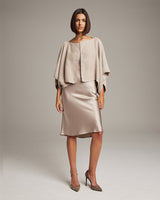 Model wearing a textured cotton bolero over a satin dress