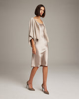 Model wearing a textured cotton bolero over a satin dress