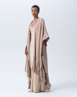 Model wearing an ivory and grey long chevron duster with fringe