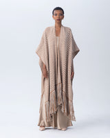 Model wearing a camel and ivory long chevron duster with fringe