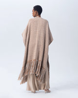 Back view of a hand-loomed long duster with chevron patterns in camel and ivory colors